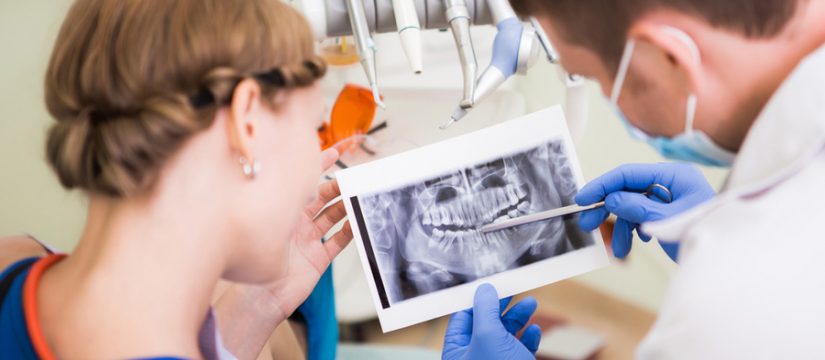 dentists looking at patient xray